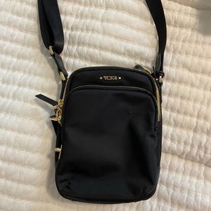Tumi black with gold hardware crossbody , perfect travel bag!!!